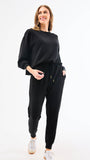 Woman wearing a black outfit on a white background