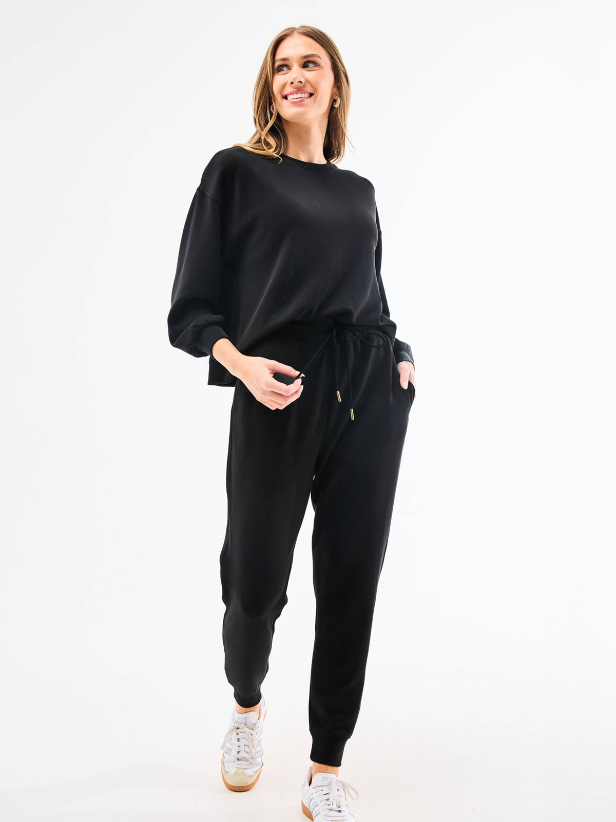 Woman wearing a black outfit on a white background