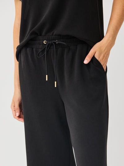 Black pants with drawstring waist on a light gray background