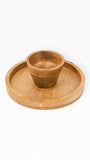 A small round wooden holder placed in the center of a larger matching wooden tray, photographed on a clean white background.