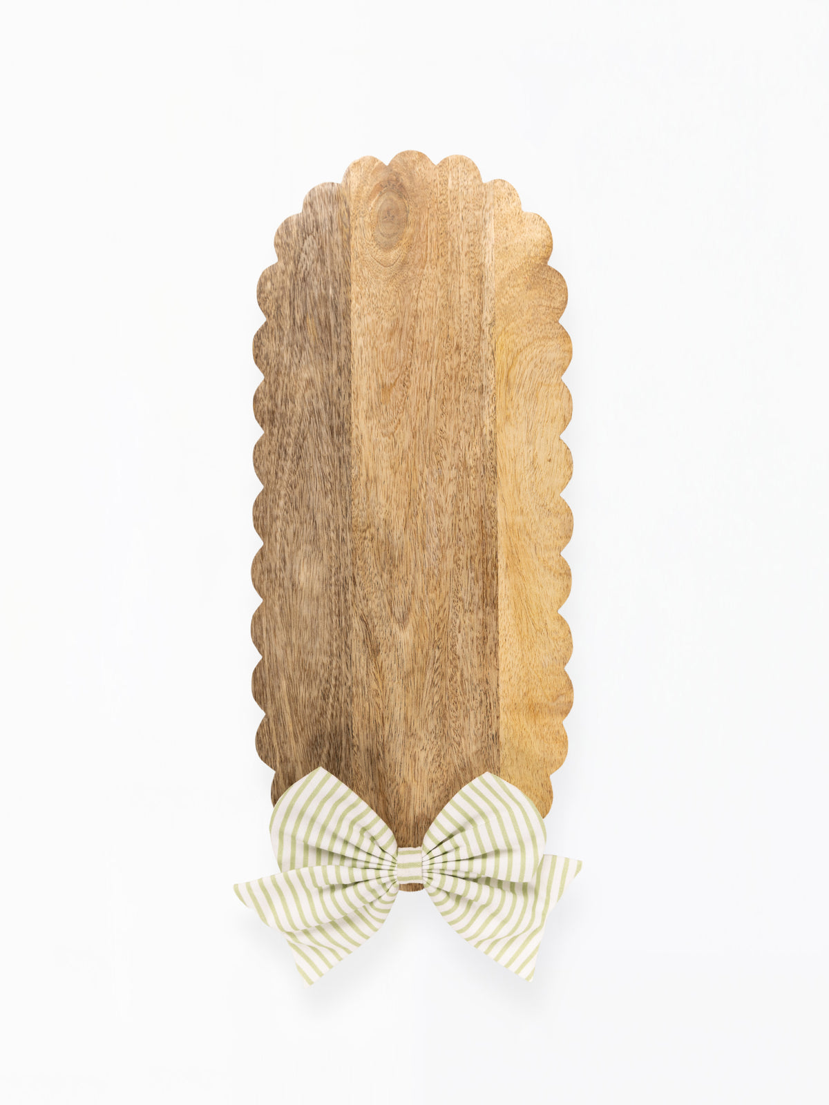 A vertical wooden serving board with a scalloped edge and a striped bow at the bottom, shown on a plain white background.