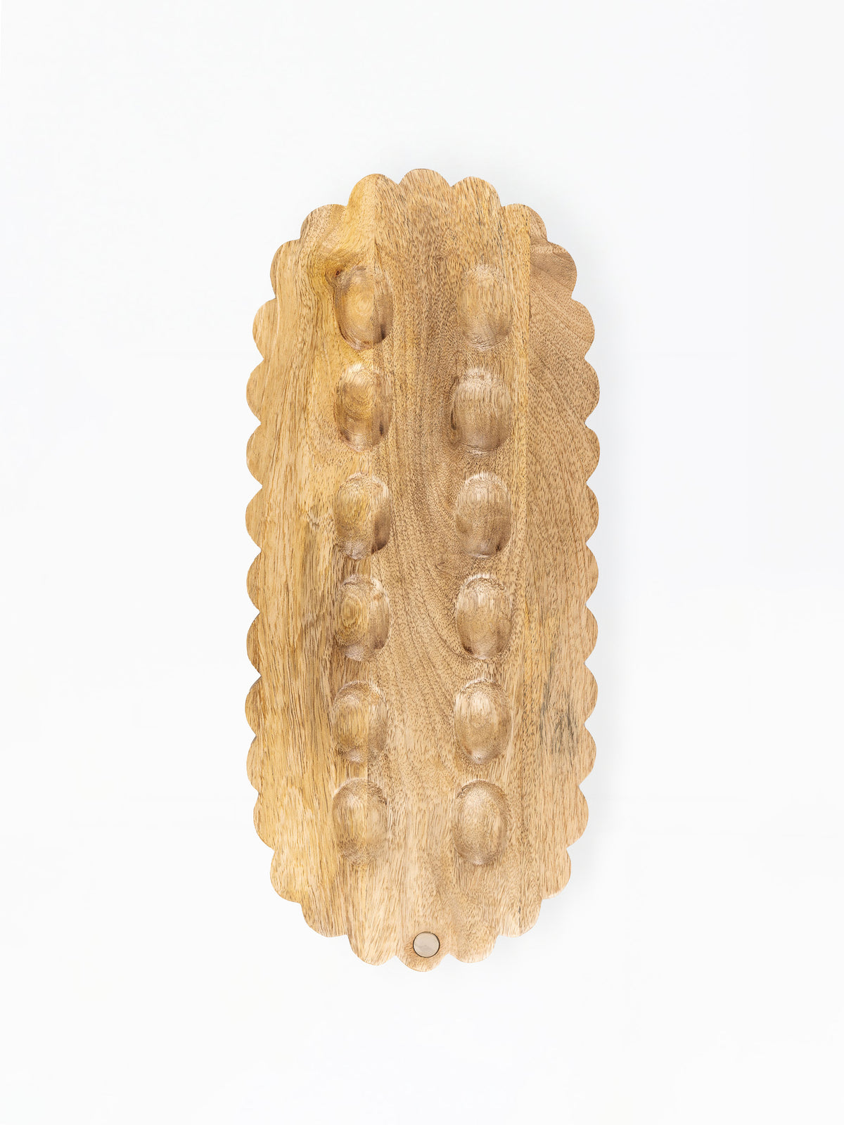 A natural wood massage board with a scalloped edge and raised circular bumps, photographed from above on a white background.