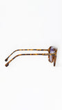 Sunglasses with tortoiseshell frame on a white background