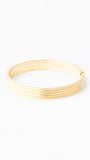 Gold bangle on a white background
