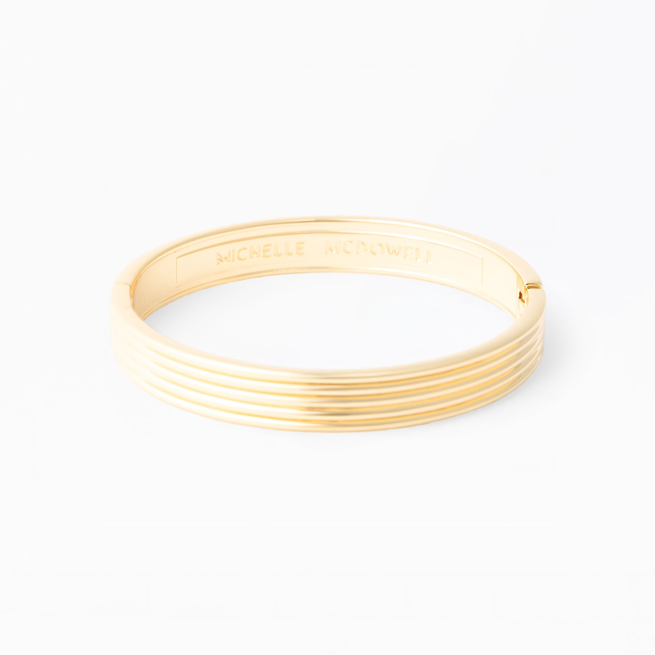 Gold bangle on a white background