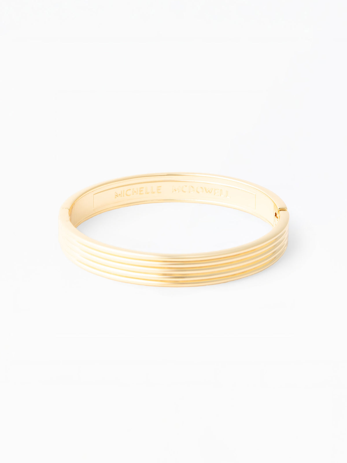 Gold bangle on a white background