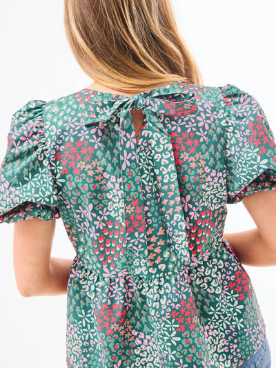 Woman wearing a floral blouse with a white background