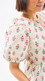 Woman wearing a floral dress with a white background
