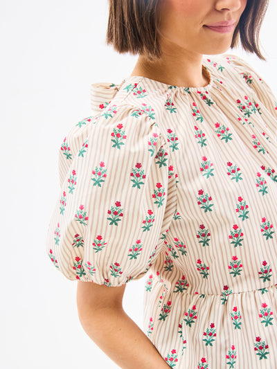 Woman wearing a floral dress with a white background