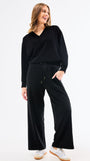Woman wearing a black outfit on a white background