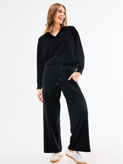 Woman wearing a black outfit on a white background