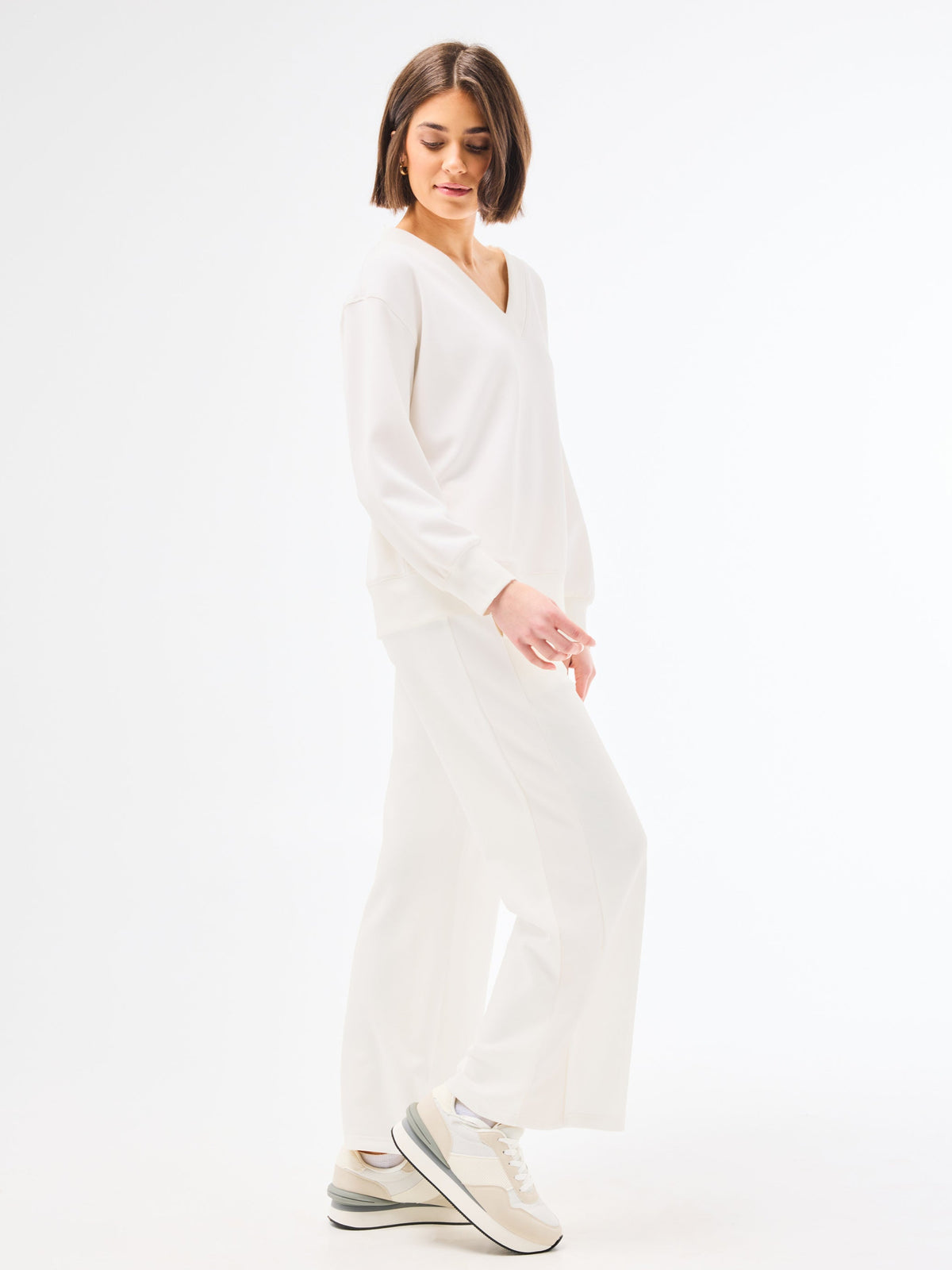 Woman wearing a white set on a white background