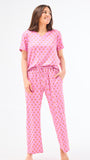 Woman wearing a floral pajama set on a white background