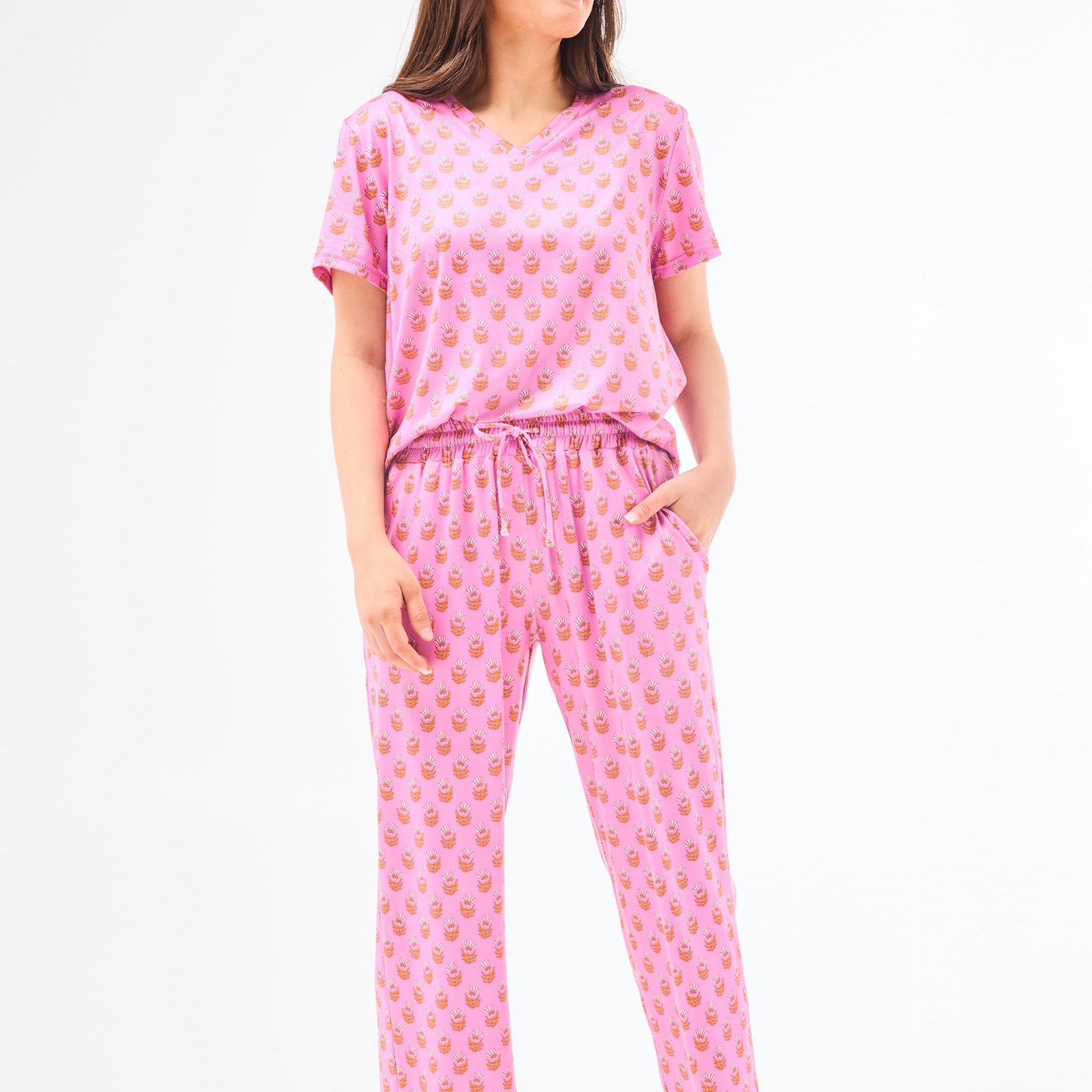 Woman wearing a floral pajama set on a white background