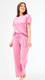 Woman wearing a floral pajama set on a white background