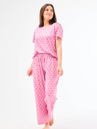 Woman wearing a floral pajama set on a white background