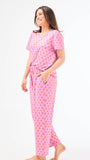 Woman wearing a floral pajama set on a white background