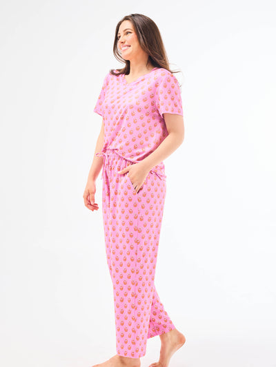 Woman wearing a floral pajama set on a white background