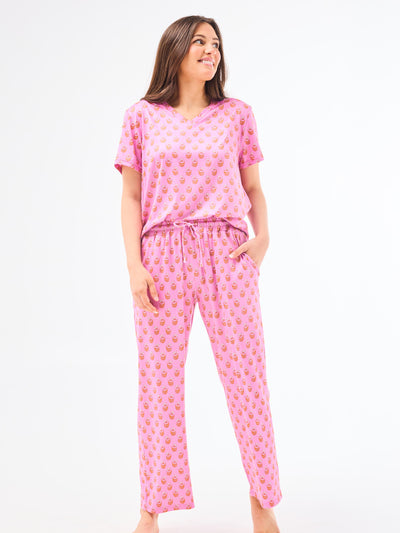 Woman wearing a floral pajama set on a white background