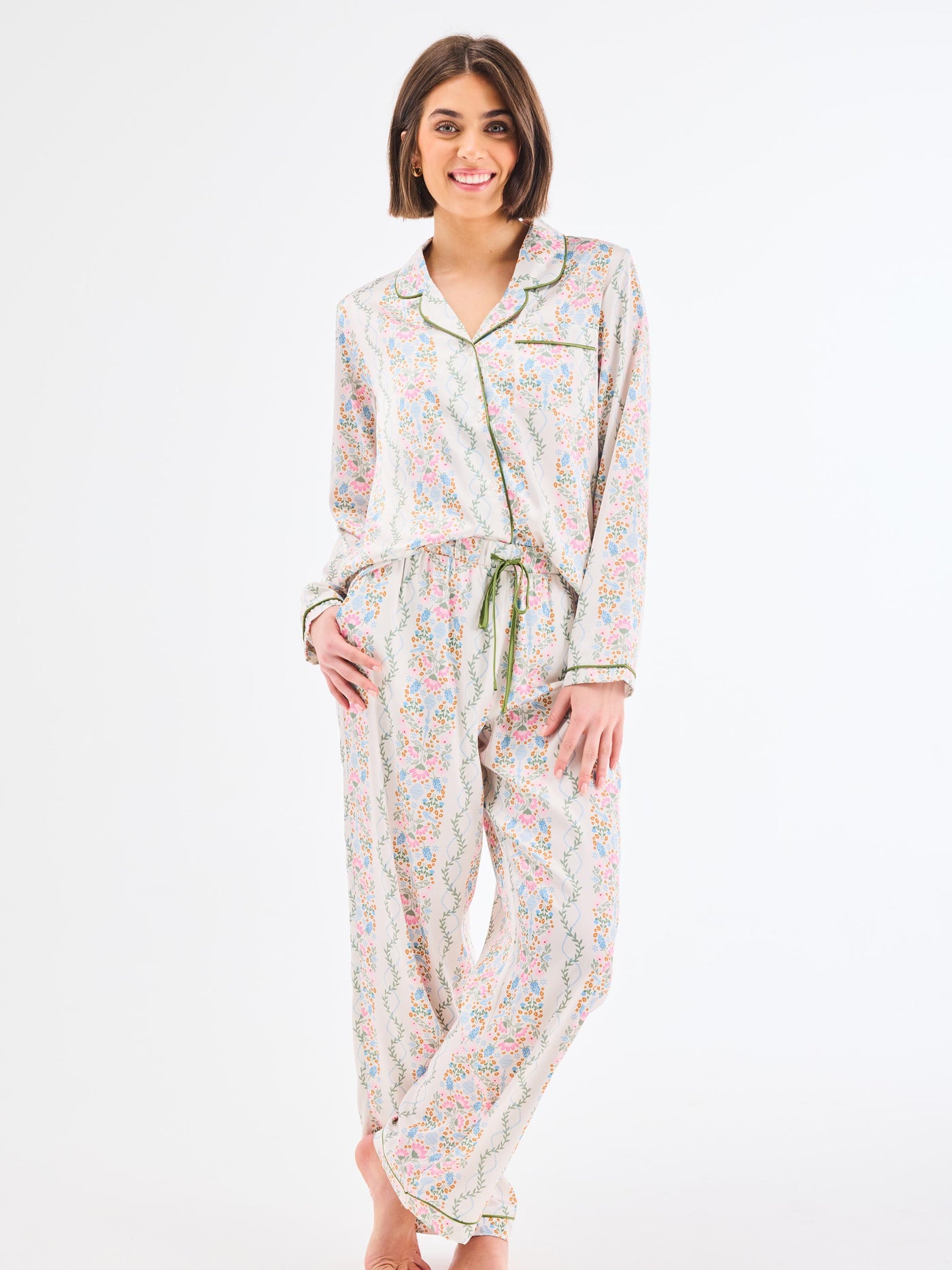 Woman wearing a floral pajama set on a white background