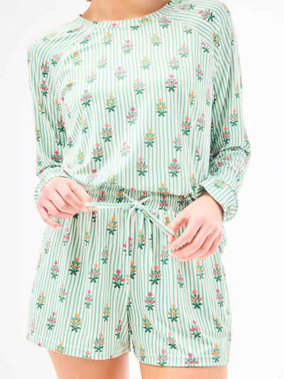 Green floral patterned pajamas on a white background