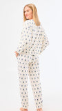 Woman wearing a patterned pajama set on a white background