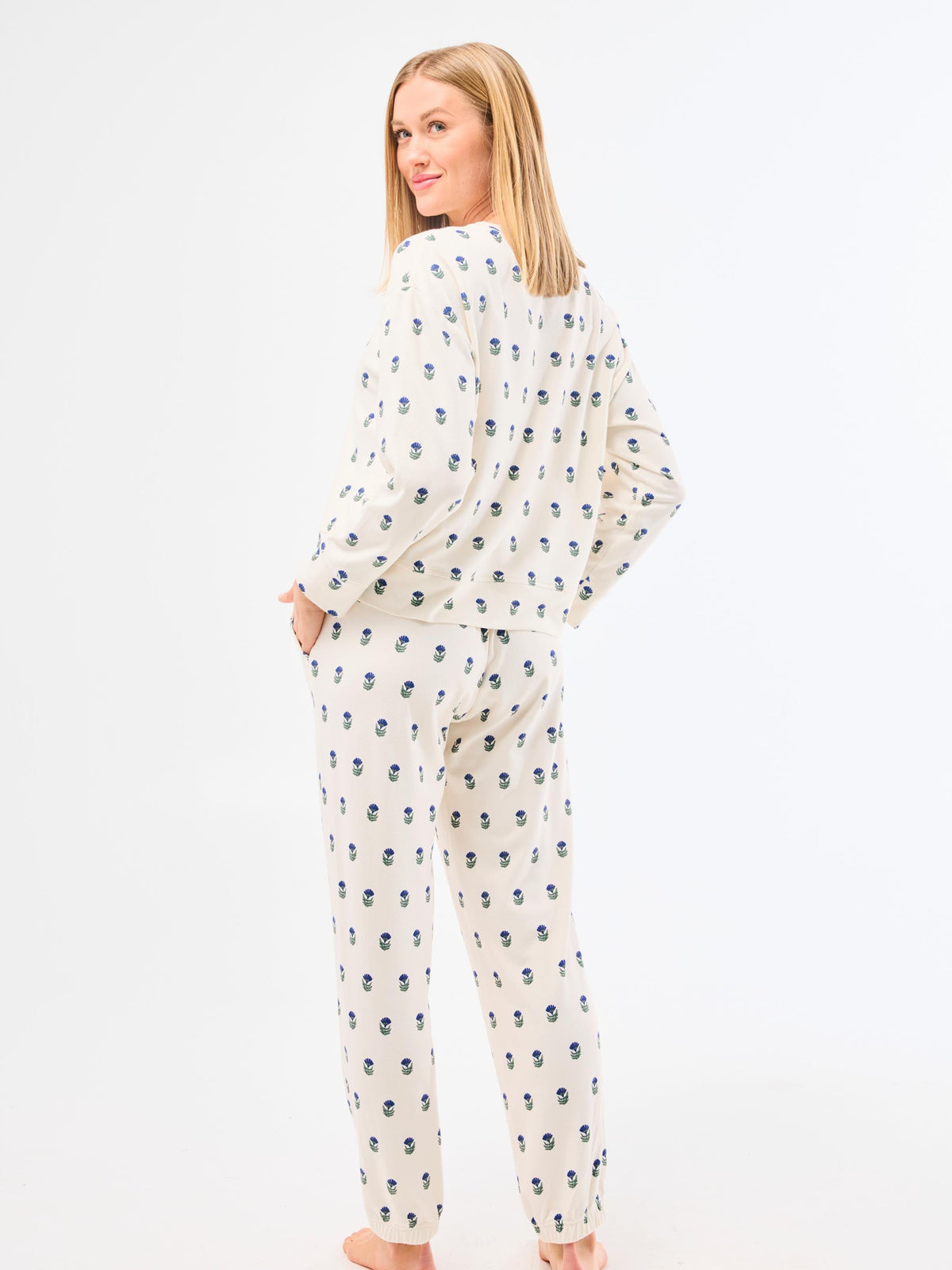 Woman wearing a patterned pajama set on a white background