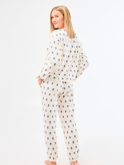 Woman wearing a patterned pajama set on a white background