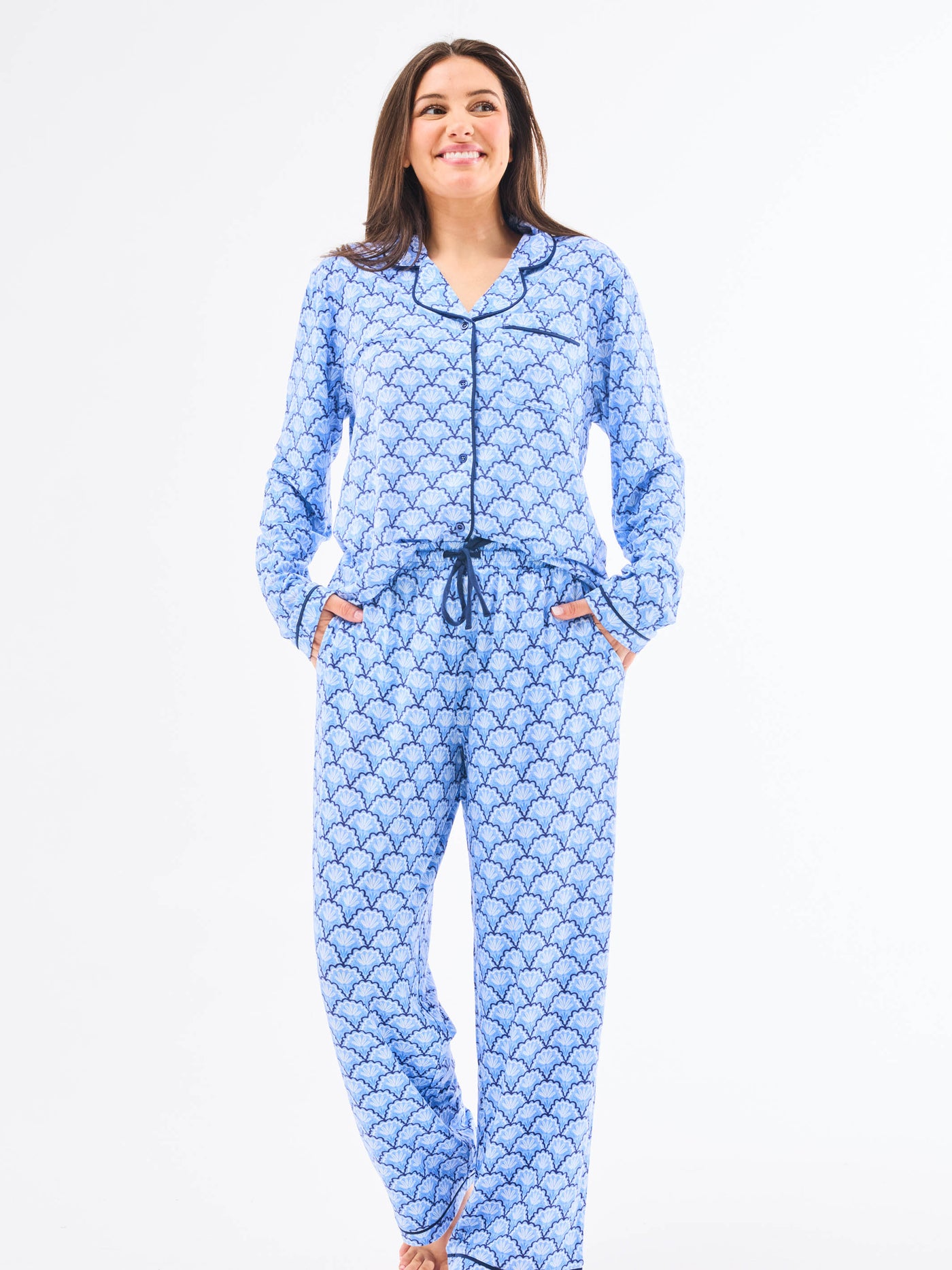 Woman wearing a blue patterned onesie on a white background