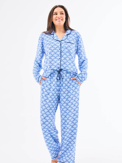Woman wearing a blue patterned onesie on a white background