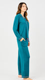 Woman wearing teal pajama set on a white background