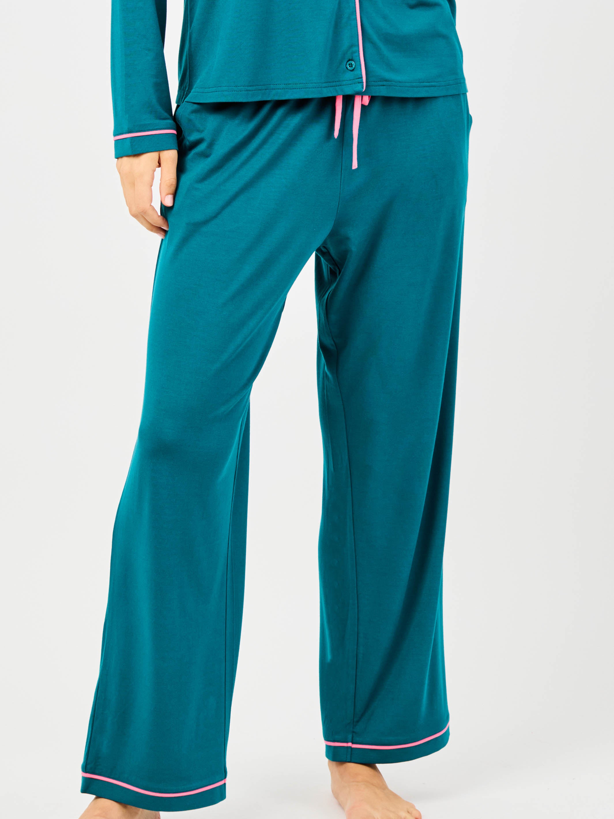 Teal pajama set with pink accents on a white background