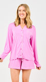 Woman wearing a pink pajama set on a white background