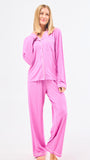 Woman wearing pink pajama set on a white background
