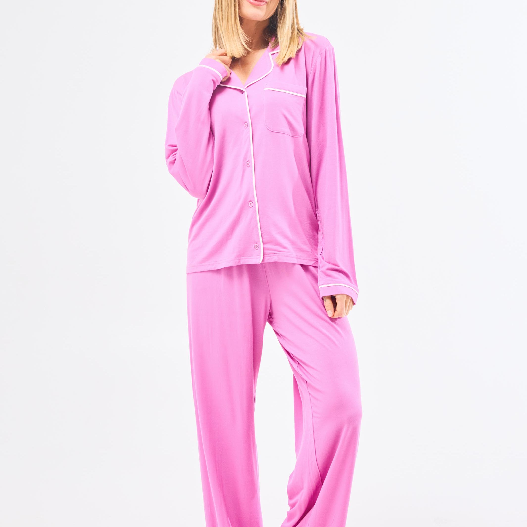 Woman wearing pink pajama set on a white background