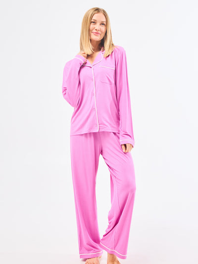 Woman wearing pink pajama set on a white background