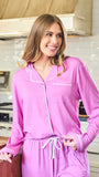 Woman wearing a pink pajama set in a kitchen