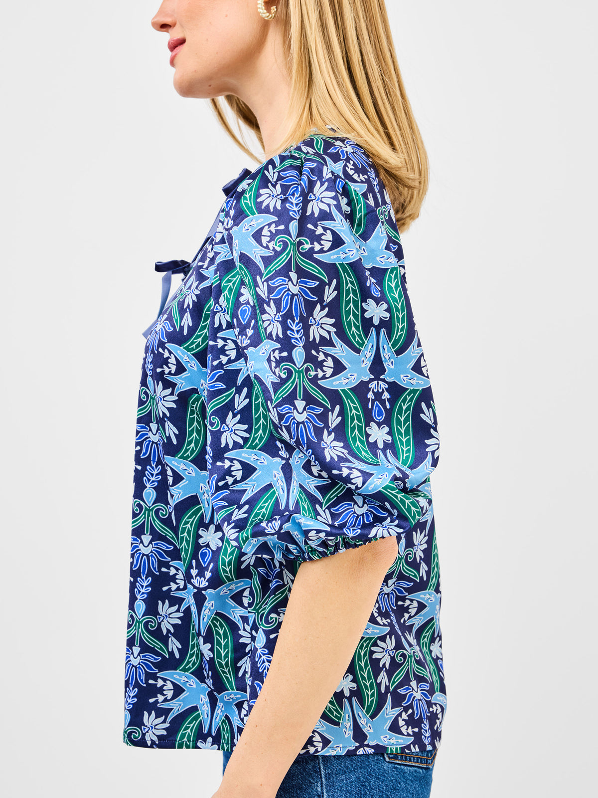 Woman wearing a blue floral patterned shirt on a white background