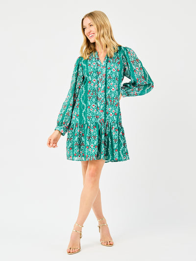 Woman wearing a green floral dress on a white background