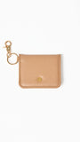 Beige leather cardholder with gold clasp on a white background
