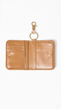 Tan wallet with keychain on a white background