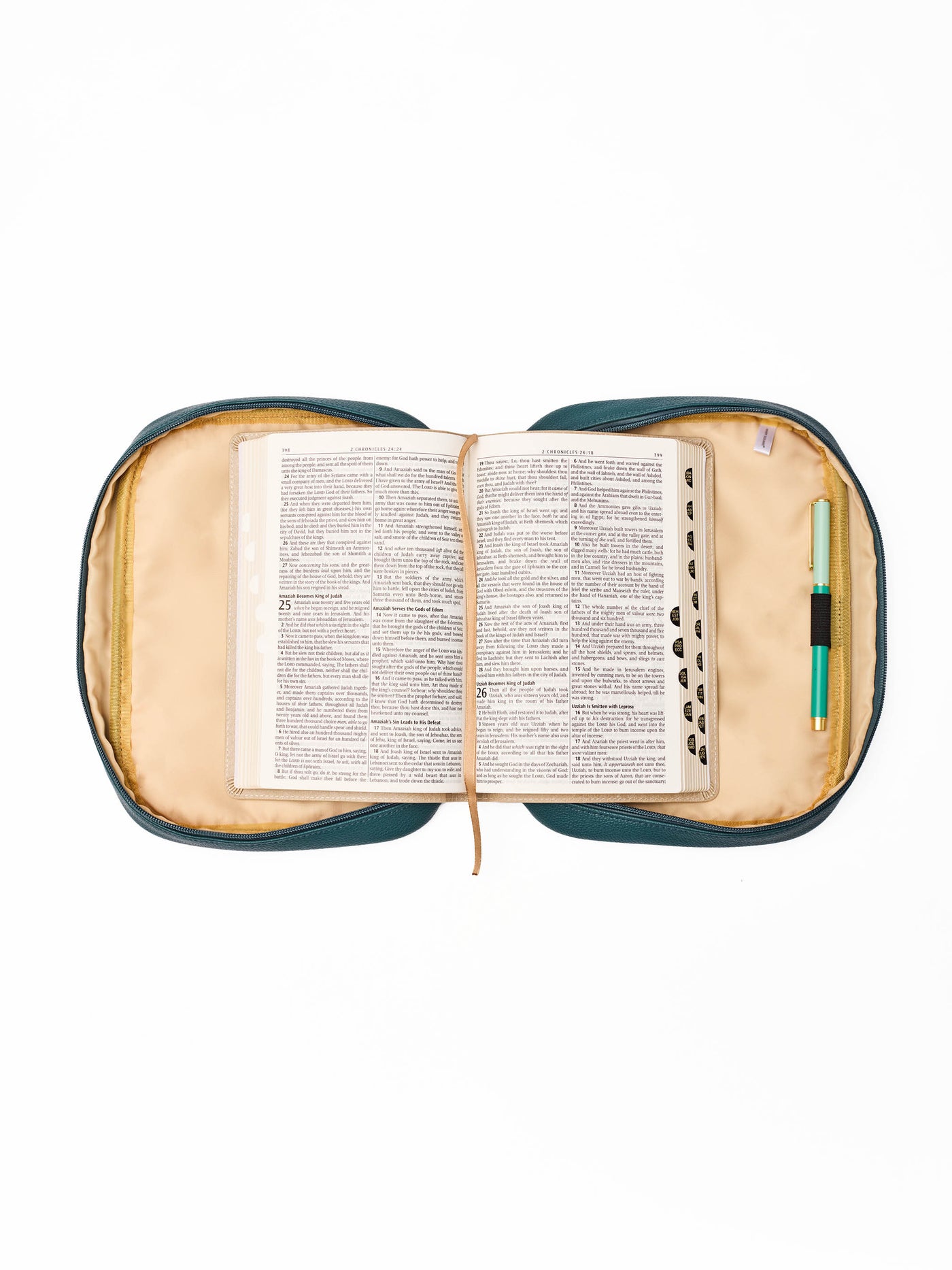 Open bible inside a teal and beige bible cover on a white background