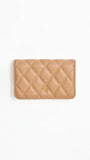 Quilted beige wallet on a white background