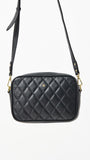 Black quilted crossbody bag on a white background