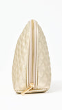 Quilted champagne colored cosmetic bag on a white background