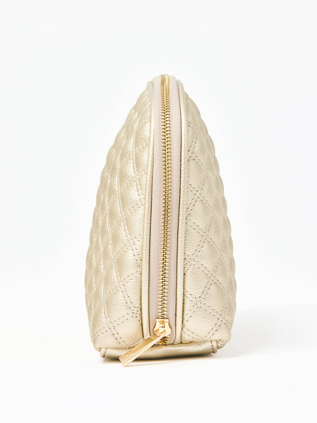Quilted champagne colored cosmetic bag on a white background