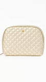 Quilted champagne colored cosmetic bag on a white background