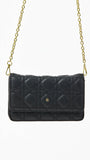 Black quilted handbag with gold chain strap on a white background