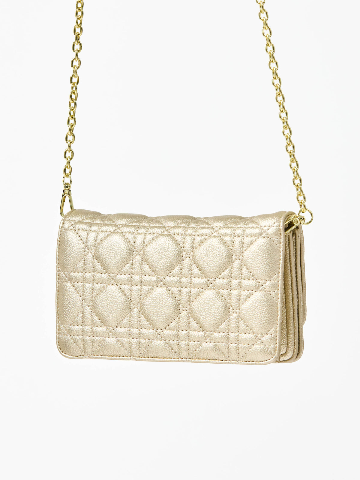 Champagne colored quilted handbag with gold chain strap on a white background