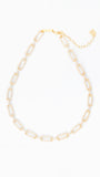 Gold necklace with rhinestone details on a white background